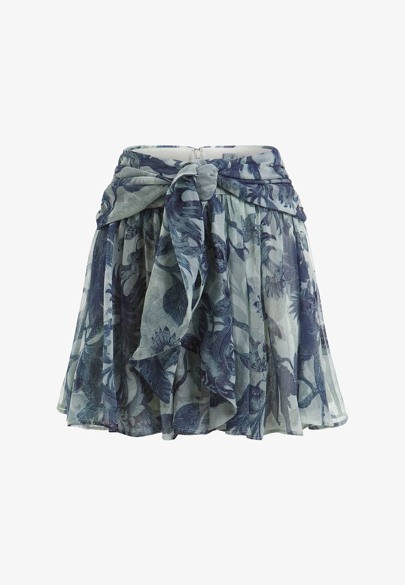 Jupe plissée à motif floral bleu et gris avec un grand nœud noué à la taille, confectionnée en tissu léger et transparent.