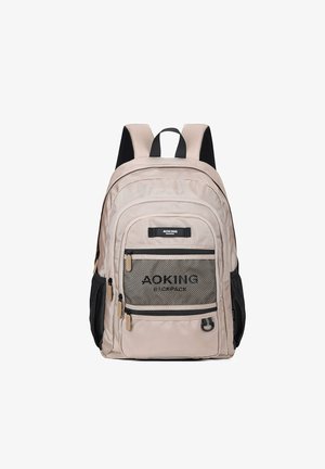 Sac à dos beige avec poche avant en mesh, accents noirs, deux poches latérales, bretelles réglables et tissu texturé. Présente un logo sur le devant.