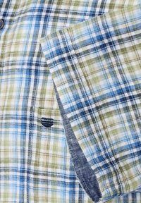Korte mouwen geruit overhemd met blauwe, groene en witte ruiten; gemaakt van lichtgewicht stof met een gestikte, donkerblauwe accent op de manchette.