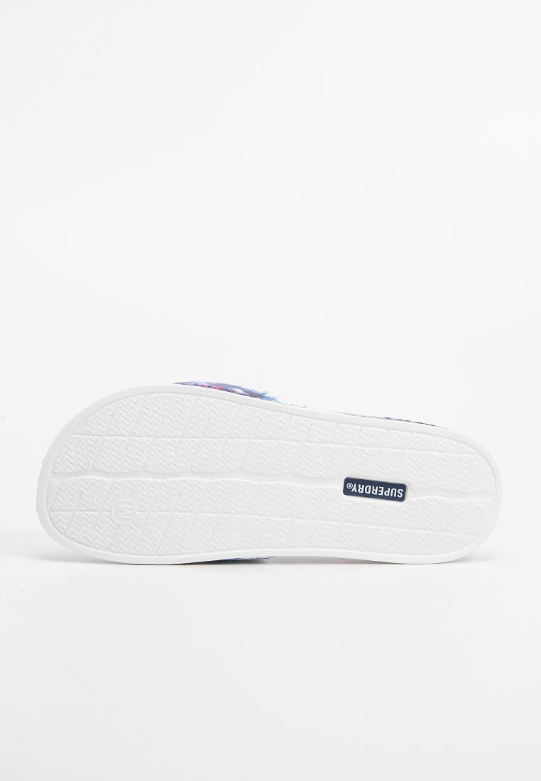 Schuhsohle mit einer strukturierten, weißen Gummisohle, die ein zentrales Logo-Etikett zeigt. Das Schuhdesign umfasst ein bunt gemustertes Obermaterial, das hier nicht sichtbar ist.