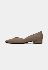 Pointed-toe beige flat shoe in suede material, featuring a low block heel and a sleek, smooth design without any visible hardware or patterns.