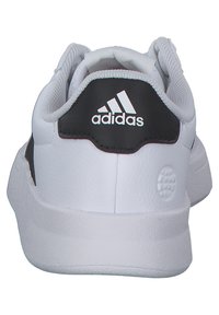 White sneakers with black accents, featuring a smooth leather upper, padded collar, and textured sole. The Adidas logo is visible on the heel.
