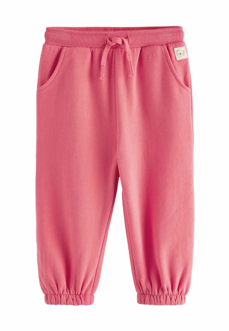 Roze katoenen joggingbroek met elastische tailleband en manchet, voorzien van twee zijzakken en een klein label op de tailleband. Zachte textuur.