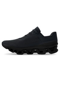 Schwarze Sportschuhe mit einem strukturierten Mesh-Obermaterial, runder Zehenpartie und einer einzigartigen segmentierten Gummisohle für verbessertes Dämpfen und Support.