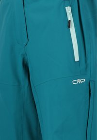Tealfärgade vattentäta byxor med en dragkedjefickan, CMP-logotyp och en slät yta med förstärkt sömnad för hållbarhet.