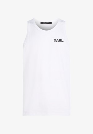 Fehér, kerek nyakú, pamut tank top. A mellrészen fekete logónyomattal rendelkezik. Egyszerű dizájnja és ujjatlan stílusa van.