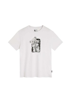 T-shirt en coton blanc avec un graphique de ours en noir et blanc dans un contour rectangulaire sur le devant. Manches courtes, design décontracté.