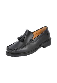 Mocasín de cuero negro con detalle de borlas, punta redondeada, bordes con costuras estilo mocasín y suela de goma texturizada para mejor agarre. Acabado liso en toda la superficie.