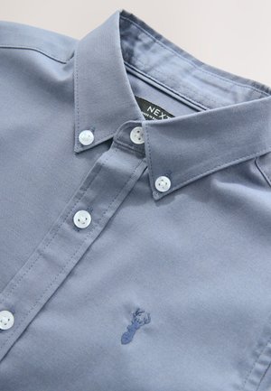 Light blue long-sleeve shirt with a button-down collar, featuring white buttons and a small embroidered lobster logo on the chest.