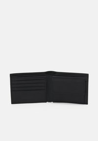 Black leather wallet, bi-fold design, featuring multiple card slots and a clear ID pocket, smooth texture, minimal branding on the front.