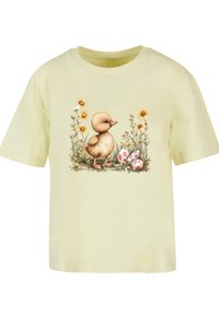 Yellow short-sleeve t-shirt featuring a printed duckling among flowers and three speckled eggs, with a soft cotton texture.