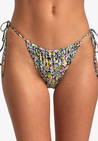 Floral print bikini bottom in black with multicolored flowers. Ties at the sides with gathered fabric and a low-rise cut. Smooth texture.