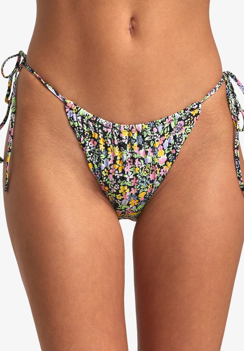 Floral print bikini bottom in black with multicolored flowers. Ties at the sides with gathered fabric and a low-rise cut. Smooth texture.