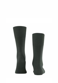 Dunkelgrüne knielange Socken aus einem glatten Material mit gerippten Bündchen. Sie haben eine figurschmeichelnde Form und eine nahtlose Konstruktion für zusätzlichen Komfort.