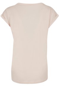 Light pink T-shirt made of soft cotton, featuring short rolled sleeves, a round neck, and a relaxed fit with a smooth texture.