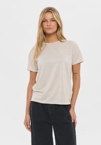 Beige short-sleeve t-shirt made of soft fabric, featuring a round neck and a relaxed fit, paired with black wide-leg pants.