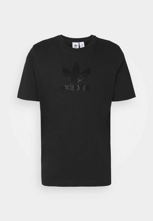 Camiseta de algodón negra con cuello redondo, que presenta un logo texturizado en un patrón de puntos. Manga corta y dobladillo recto.