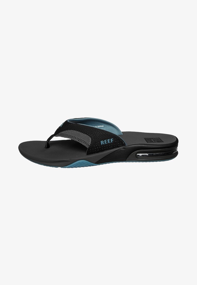Black flip-flops with a textured strap, blue accents, and a cushioned sole. Features an air pocket in the heel for added comfort.