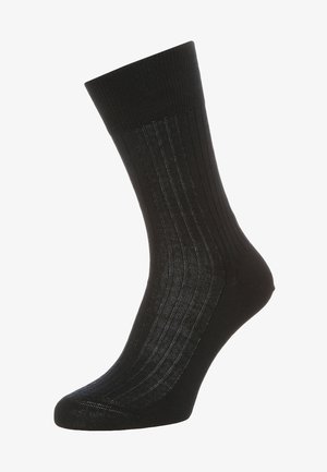 Black ribbed sock made of a smooth, stretchy material. Features a reinforced toe and elasticized cuff for a secure fit.