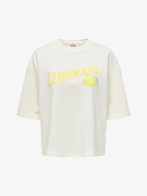 T-shirt oversize blanc cassé avec "LIMONATA" en lettres jaunes et un motif de citron tranché sur le devant.