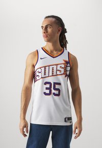 Maillot de basket-ball blanc avec des accents en violet et orange. Présente le texte "SUNS", le numéro "35" et le logo Nike. Fabriqué en tissu en maille.