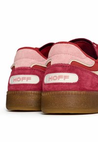 Red suede sneakers with pink accents. Features a textured brown rubber sole and a back panel displaying "HOFF" in white lettering.