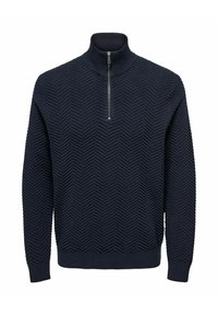 Pull en tricot texturé bleu marine avec un motif en chevrons, manches longues, poignets et ourlet côtelés, col montant et fermeture zippée mi-longue à l'avant.