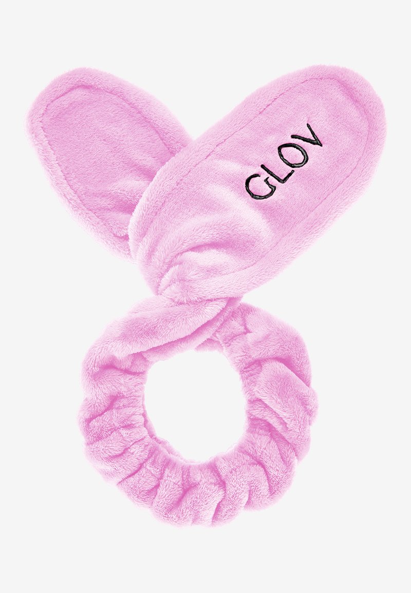Rosa mjuk tygband med kaninöron och ordet "GLOV" broderat, samt en cirkulär scrunchie-bas för en säker passform.