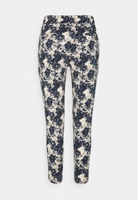 Legíny v námořnické modři a smetanové barvě se vzorem, s úzkým střihem, vyrobené z elastického materiálu. Mají vysoký pas a květinový abstraktní design.