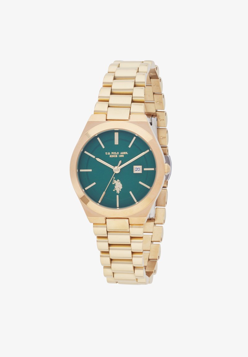 Montre en métal doré avec un cadran vert, boîtier octogonal, index des heures argentés et affichage de la date. Présente un bracelet à maillons.