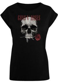 T-shirt noir à manches courtes avec un design graphique représentant une tête de mort ornée d'une rose rouge et le texte "GUNS N' ROSES" en rouge vif au-dessus.