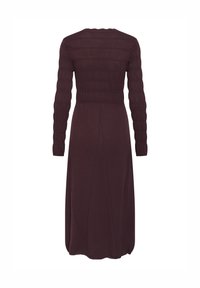 Long, burgundy dress featuring a ribbed bodice, long sleeves, and a flowing skirt. Made from a soft, stretchy fabric with a smooth texture.