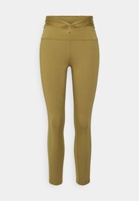 Olivgrüne Leggings mit einem hohen, verdrehten Bund, aus dehnbarem Material gefertigt, mit einer glatten Textur und figurbetonter Silhouette.