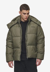 Olive green puffer jacket with a zip front, large hood, and stitched panels. Features logo on chest and thick insulation for warmth.