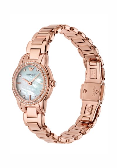 Dameur i rosaguldfarvet rustfrit stål med perlemorsskive, krystal timeindikatorer og krystalbesat bezel, ledet armbåndsrem.
