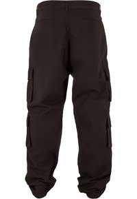 Pantalon cargo marron foncé vu de dos, avec plusieurs poches à rabat sur les côtés et à l'arrière.