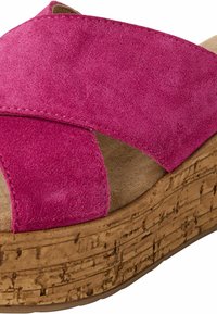 Pink suede slide sandal with crisscross straps and a cork platform sole featuring a textured finish.