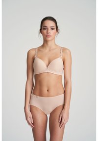 Nude-colored bra with lightly padded cups, scalloped strap detail, and decorative center accent; matching high-waisted brief.