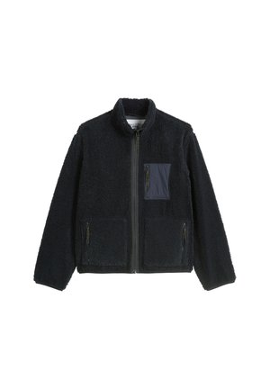Black full-zip fleece jacket with high collar, two lower front pockets, and one zippered chest pocket with a contrasting fabric patch.