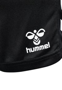 Black athletic shorts featuring a white "hummel" logo and a bee design on the lower side, made from smooth, lightweight material.