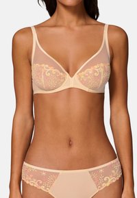 Lacy beige bra and matching brief featuring floral embroidery in pink and green. Translucent mesh cups offer a delicate look.