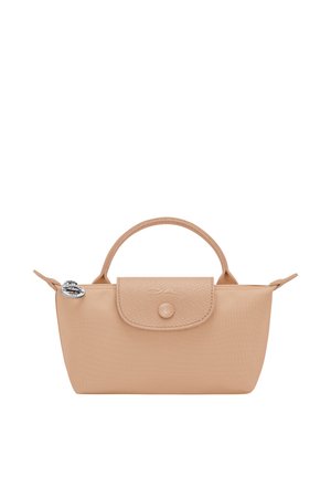 Small beige handbag with rounded handle, flap with button closure, and silver round charm on zipper pull.
