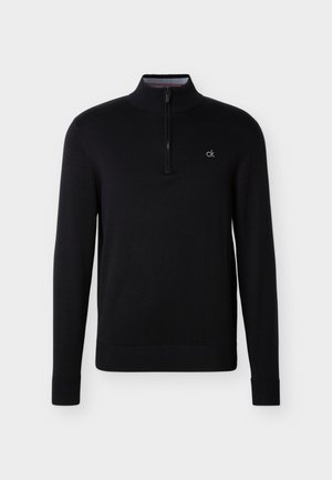 Black long-sleeve pullover with quarter-zip front and small white "ck" logo on the left chest, featuring ribbed collar, cuffs, and hem.