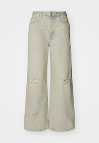 Light-wash denim wide-leg jeans with distressed rips and frayed edges. Features a button closure and five-pocket design.