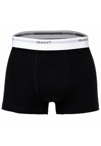 Boxer neri in cotone con elastico bianco riportante il nome del marchio "GANT" in grigio. Il design è aderente con una forma classica.