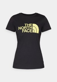 Černé bavlněné tričko s velkým žlutým logem "THE NORTH FACE" s zakřiveným designem, krátkými rukávy a kulatým výstřihem.