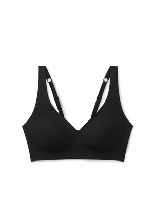 Zwarte naadloze draadloze beha met verstelbare bandjes en gevormde cups, ontworpen voor comfortabel dagelijks gebruik en een soepele pasvorm.