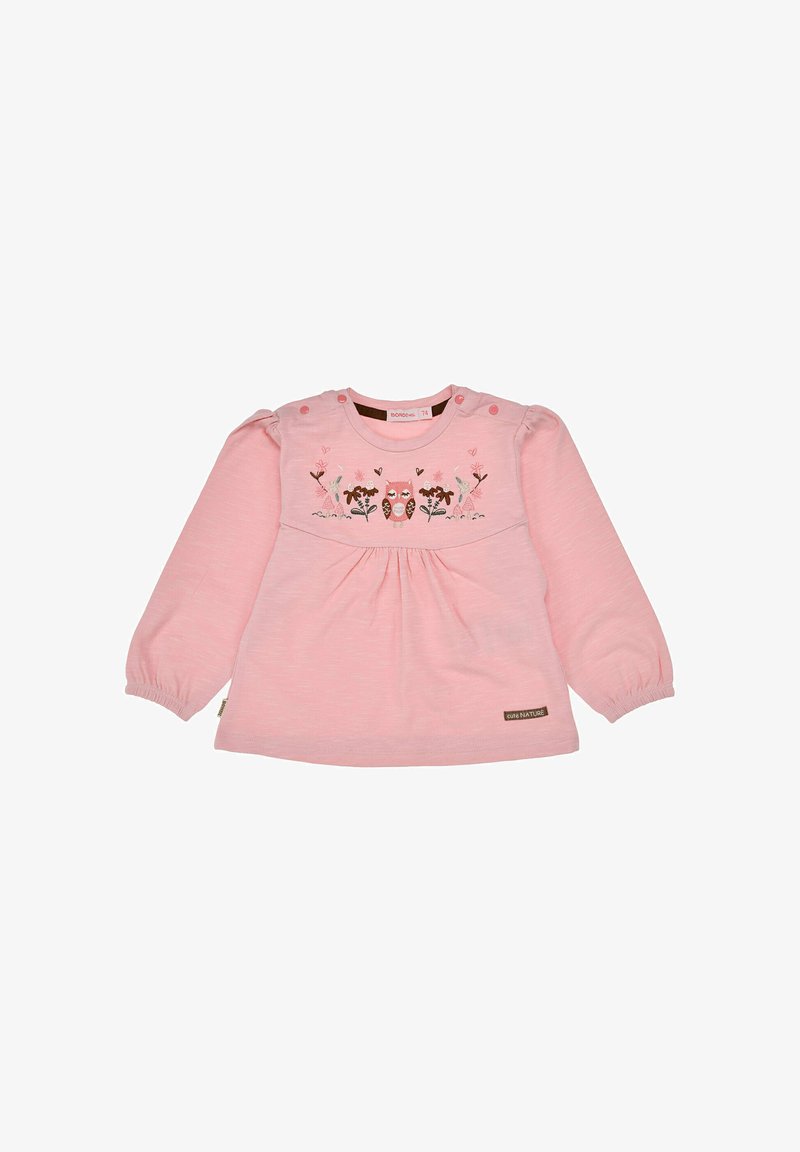 Rosa Langarmshirt aus weichem Stoff, mit floralem Stickerei und Knopfakzenten an der Schulter. Plissierter Stil an der Taille.