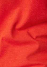 Red fabric with a smooth texture, featuring slight creases. The material appears stretchy and lightweight, suitable for clothing.