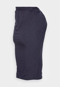 Tmavě námořnická sukně do kol, vyrobená z jemného, elastického materiálu. Obsahuje nabíraný pás a draped design pro přiléhavý siluetu.